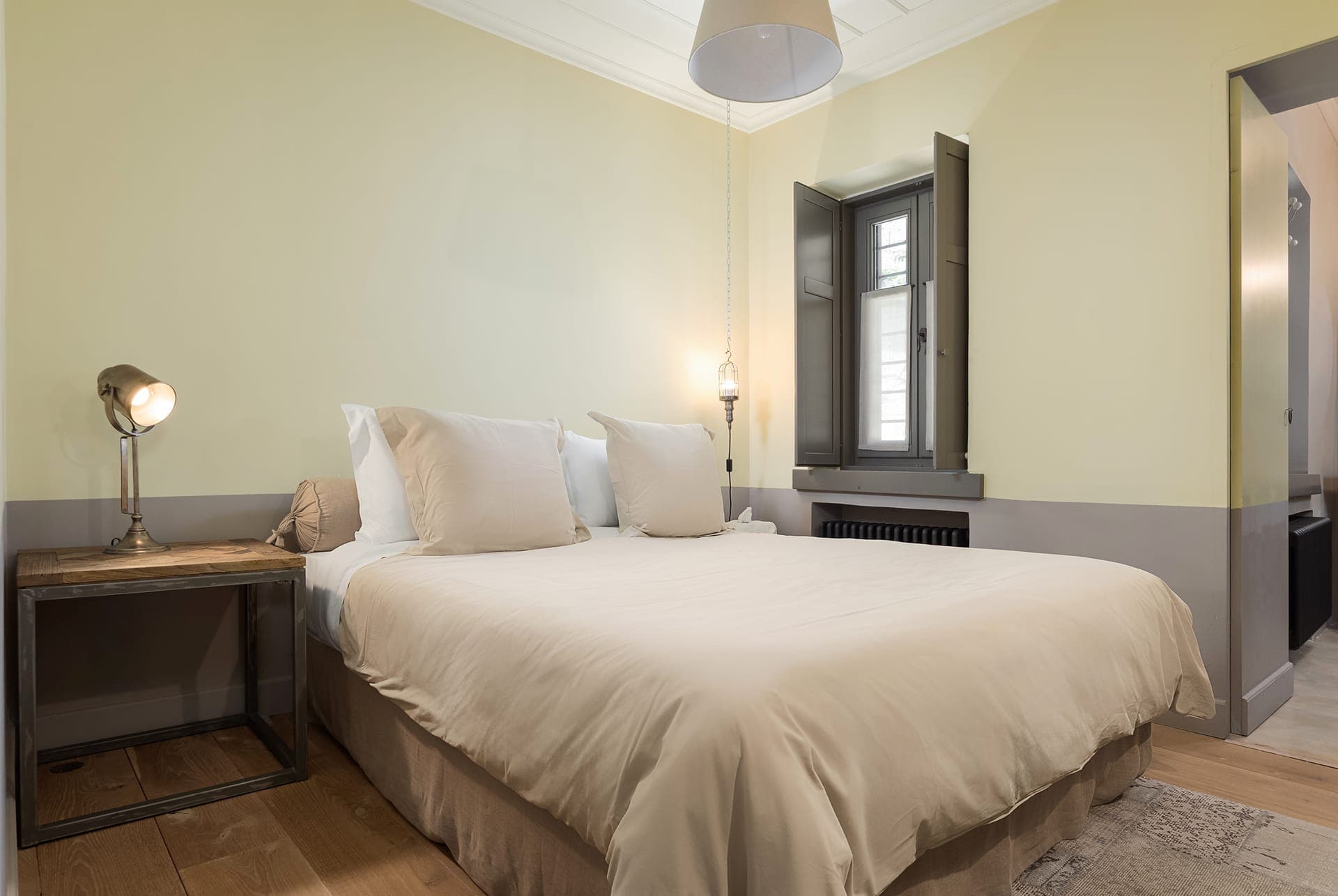 The Yellow Room bedroom with courtyard and village views.