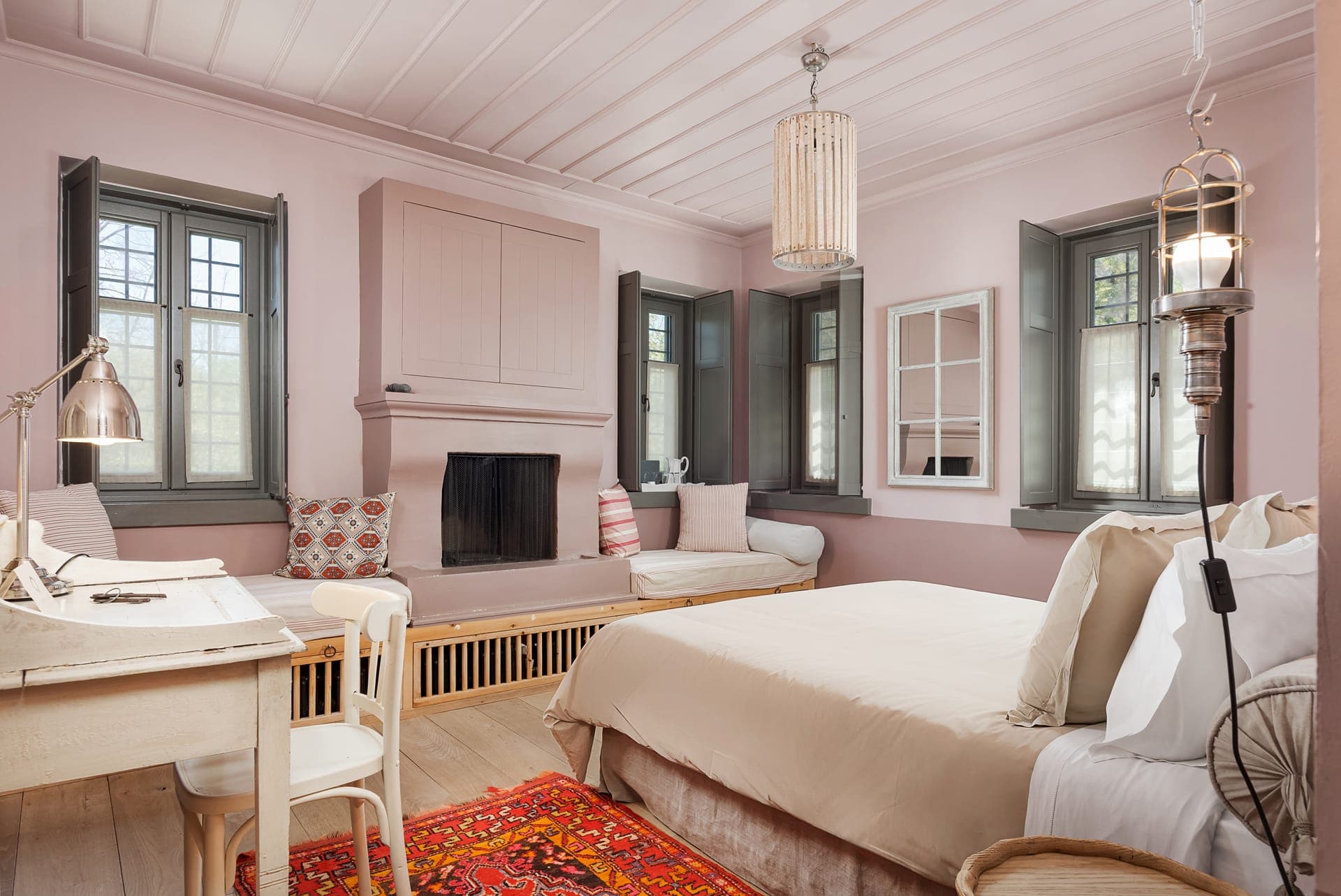 Pink Room with fireplace and seating area in the historic Apeiros Chora mansion.