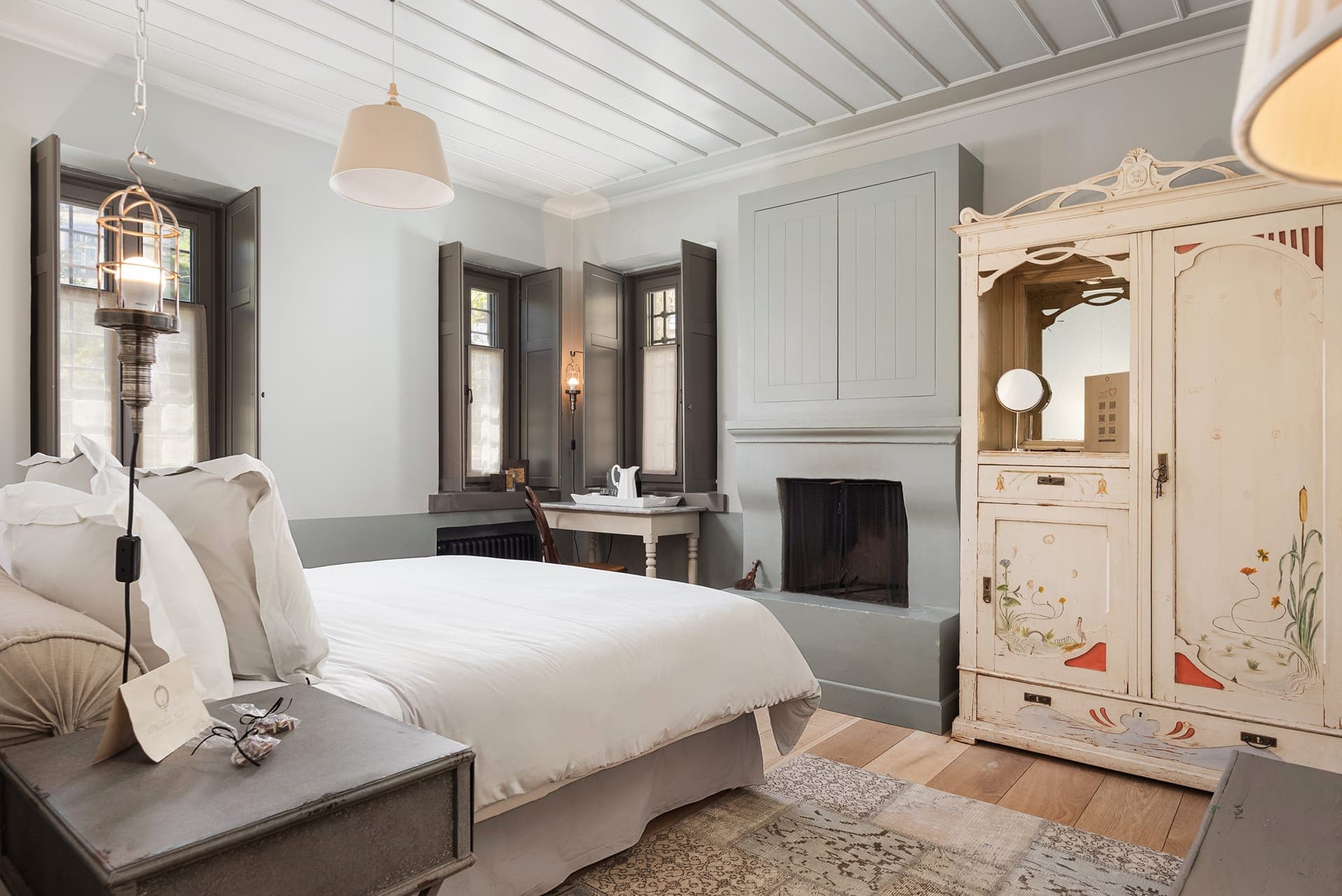 Green Room with fireplace, writing desk, and village views.