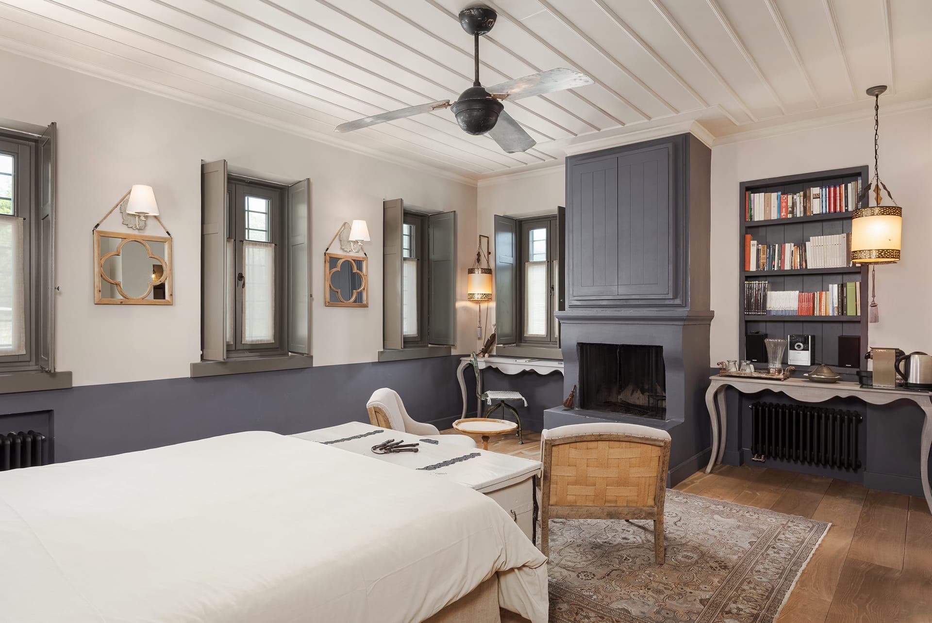 Purple Suite master bedroom with fireplace, coffee corner, and library.