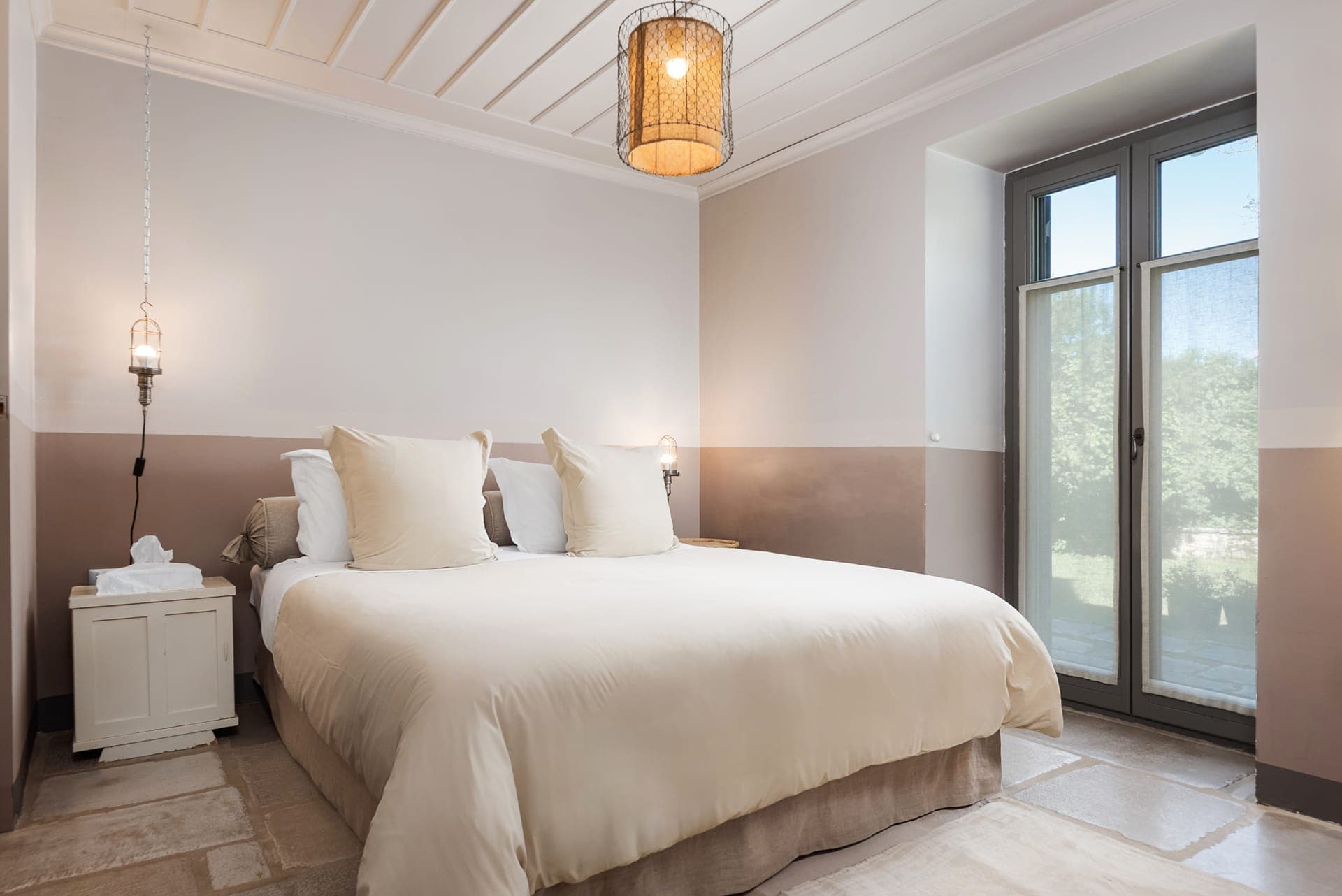 Family Suite Brown bedroom with direct courtyard access and garden views.