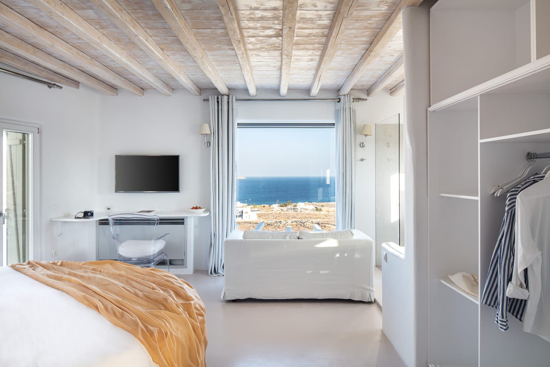 Extravaganza Suite 55m2 | Open plan, en suite shower, with round Super King size bed, double sink and WC Luxurious circular bed with COCO-MAT mattress and linen TV. Private furnished terrace with pool/jacuzzi and seating area, Panoramic Sea views.
